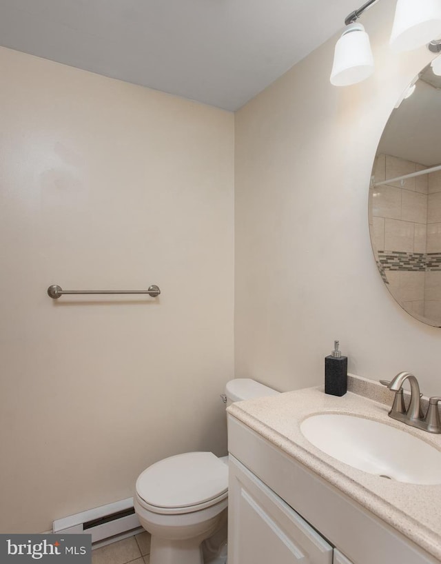 bathroom with a baseboard heating unit, toilet, vanity, and tile patterned floors