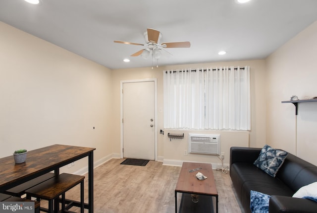 living area featuring baseboards, a ceiling fan, a wall mounted air conditioner, recessed lighting, and light wood-style floors