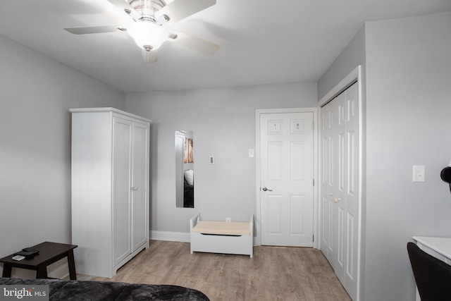 bedroom with light wood-style floors, a closet, baseboards, and a ceiling fan
