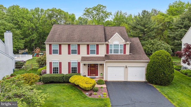 view of front facade featuring asphalt driveway and an attached garage