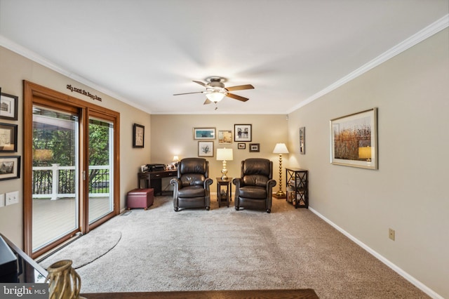 living area with ornamental molding, carpet floors, a ceiling fan, and baseboards