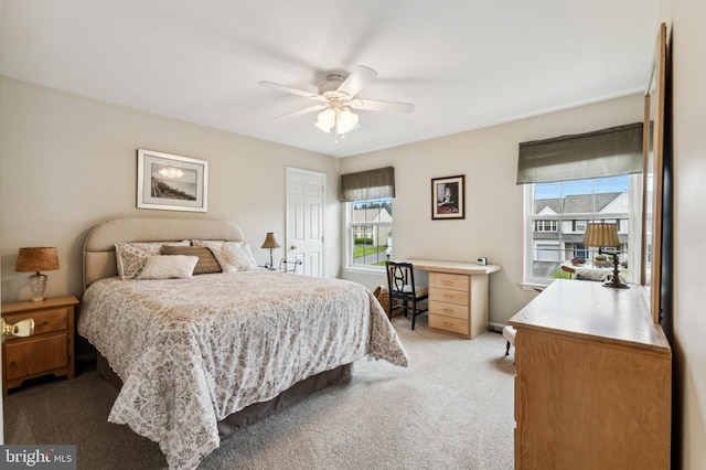 bedroom with light colored carpet and a ceiling fan