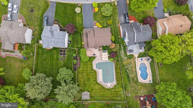 aerial view of property and surrounding area featuring nearby suburban area