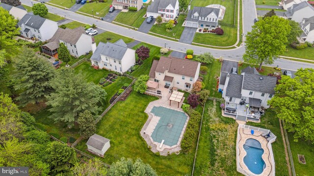 aerial perspective of suburban area featuring a pool area