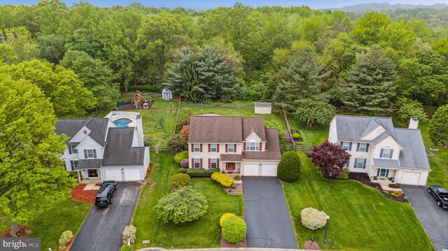 view from above of property with a heavily wooded area