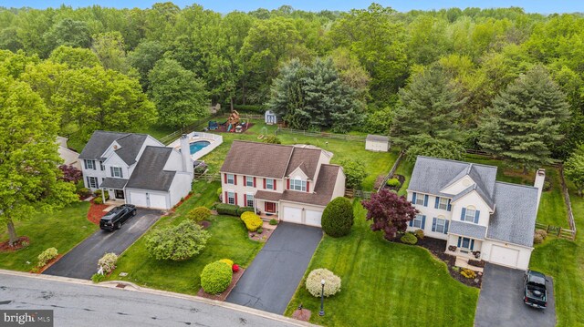 aerial view of residential area featuring a heavily wooded area