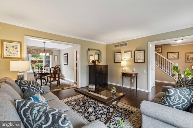 living area featuring wood finished floors, a chandelier, crown molding, stairs, and baseboards