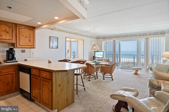 6109 Atlantic Ave Unit 201, Ocean City, MD 21842 - kitchen with dishwasher, a kitchen breakfast bar, a peninsula, open floor plan, and light countertops