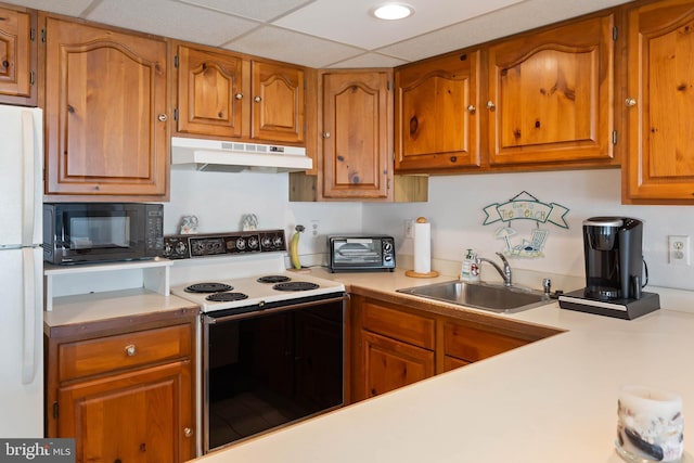 6109 Atlantic Ave Unit 201, Ocean City, MD 21842 - kitchen with under cabinet range hood, electric range, black microwave, a sink, and freestanding refrigerator