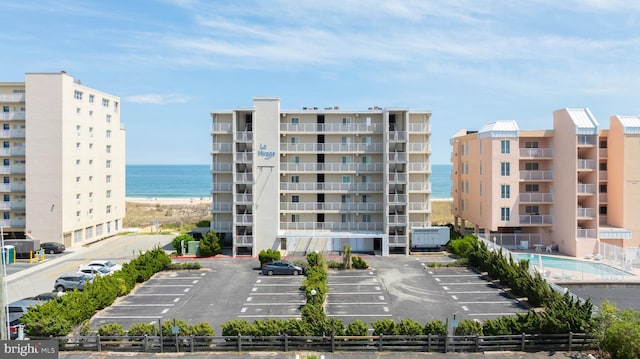 6109 Atlantic Ave Unit 201, Ocean City, MD 21842 - view of apartment building / complex with uncovered parking, fence, and a water view