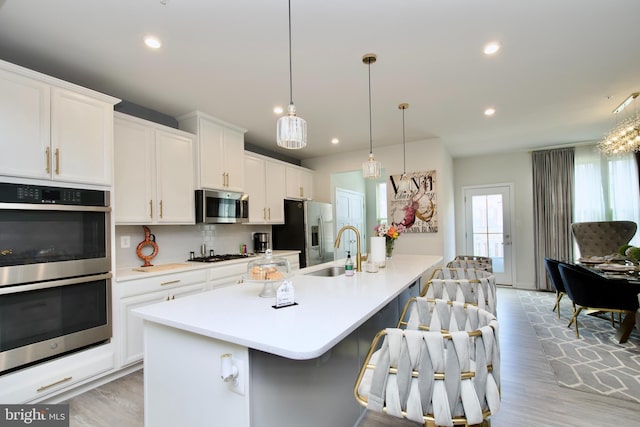 10810 Norbourne Farm Rd, Upper Marlboro, MD 20772 - kitchen featuring appliances with stainless steel finishes, a sink, a large island, white cabinets, and tasteful backsplash