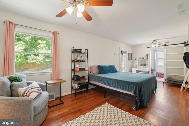 5728 Sunbury Dr, Alexandria, VA 22303 - bedroom featuring a barn door, wood finished floors, and ceiling fan