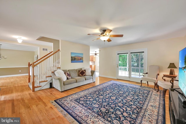 488 Seedling Ct, Mechanicsburg, PA 17055 - living room with a ceiling fan, stairway, light wood finished floors, a chandelier, and baseboards