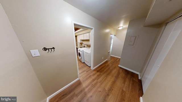10239 Prince Pl Unit 26-T1, Upper Marlboro, MD 20774 - hall featuring washing machine and dryer, light wood-style flooring, baseboards, and a sink