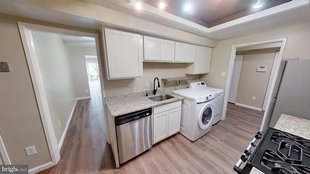 10239 Prince Pl Unit 26-T1, Upper Marlboro, MD 20774 - laundry room featuring light wood-type flooring, washer / dryer, and baseboards