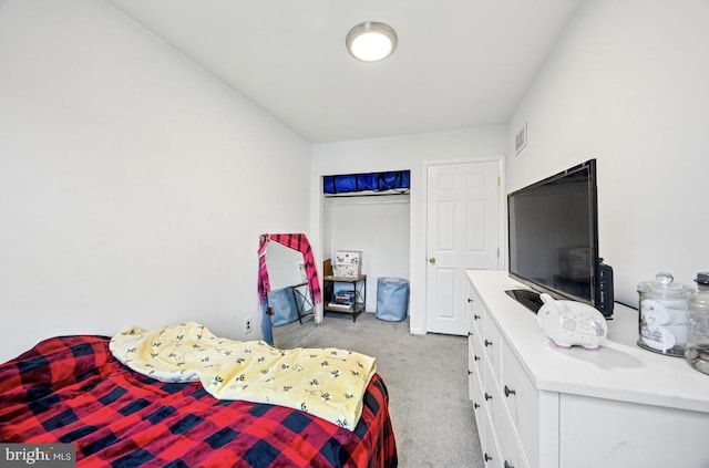 carpeted bedroom with a closet