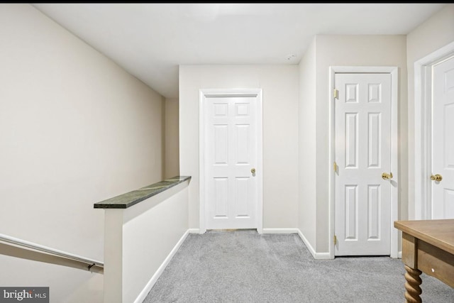 hall with carpet flooring and baseboards