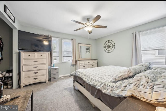 carpeted bedroom featuring a ceiling fan and baseboards