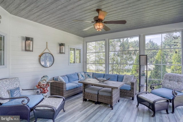 sunroom / solarium with an outdoor living space and ceiling fan