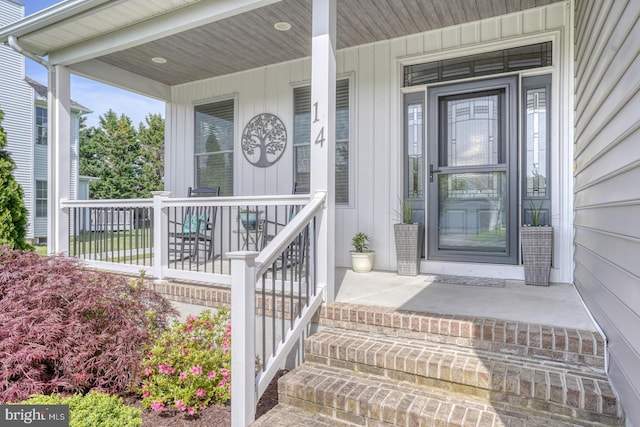 view of exterior entry with a porch