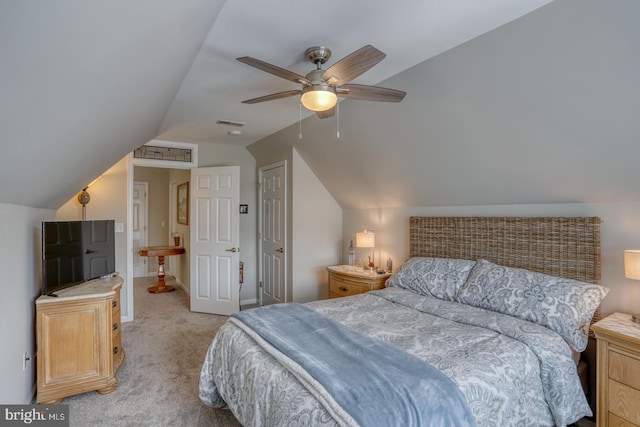 bedroom featuring light colored carpet, vaulted ceiling, and ceiling fan