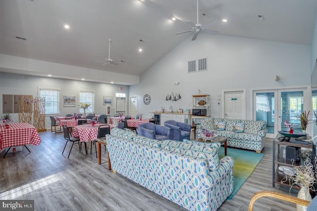 living area featuring ceiling fan, high vaulted ceiling, wood finished floors, and recessed lighting