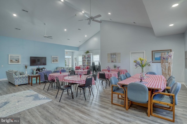 dining space with ceiling fan, high vaulted ceiling, wood finished floors, recessed lighting, and baseboards