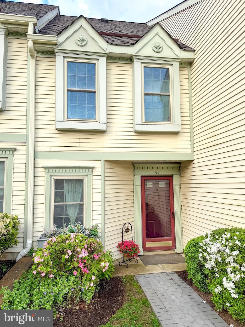 doorway to property with a shingled roof