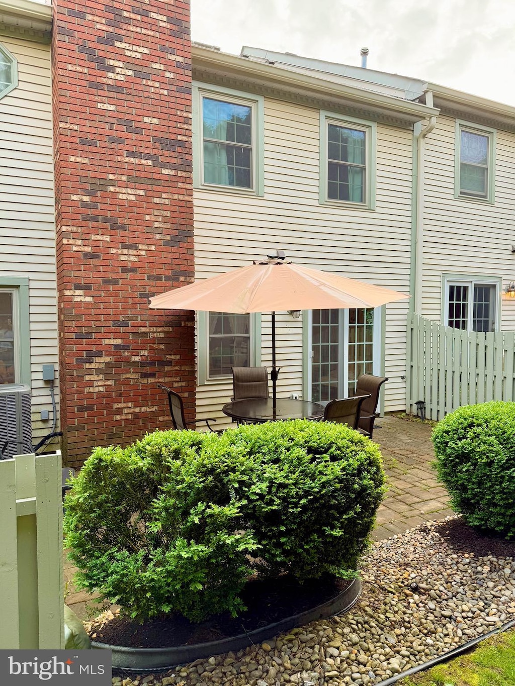 rear view of house with fence and central air condition unit