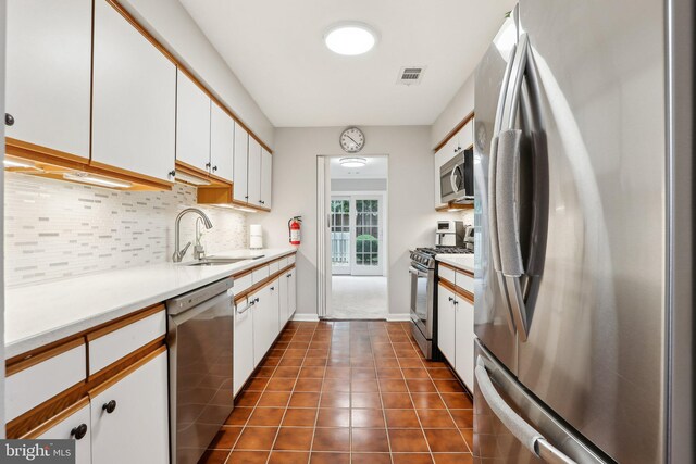 41 Fair Acres Ct, Princeton, NJ 08540 - kitchen featuring stainless steel appliances, a sink, decorative backsplash, white cabinets, and light countertops