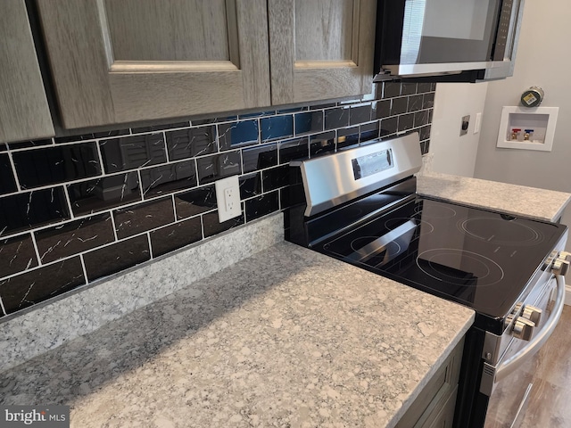 5335 W Girard Ave, Philadelphia, PA 19131 - kitchen with appliances with stainless steel finishes and decorative backsplash