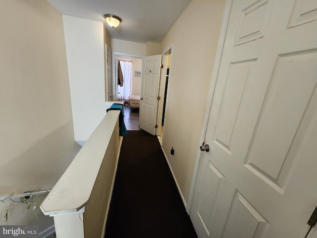 corridor featuring baseboards