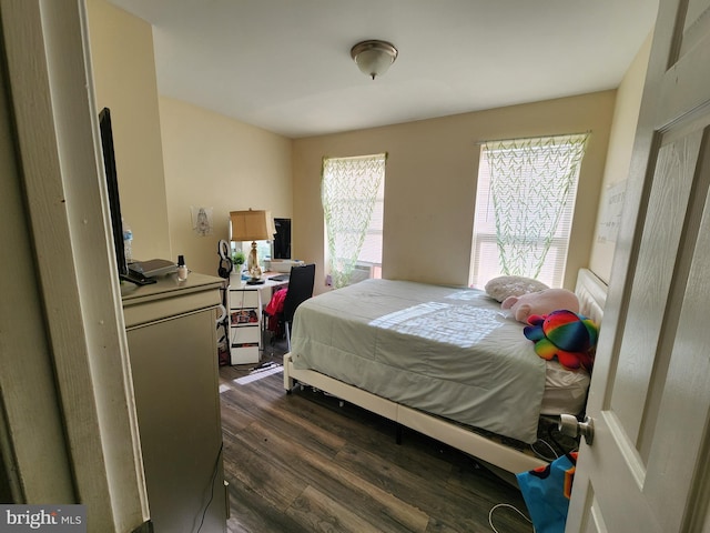 bedroom with dark wood-style flooring