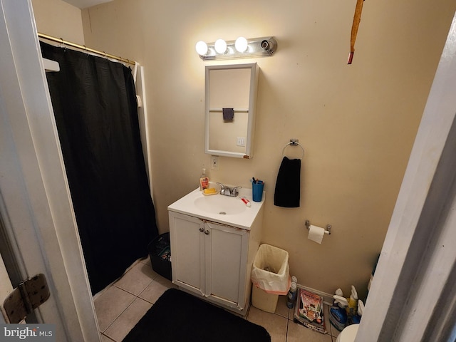 bathroom with tile patterned floors, vanity, and curtained shower