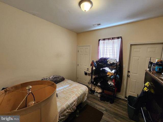 bedroom featuring dark wood finished floors