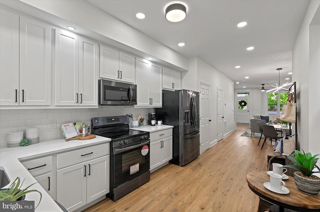 kitchen featuring black / electric stove, fridge with ice dispenser, tasteful backsplash, recessed lighting, and light wood-type flooring