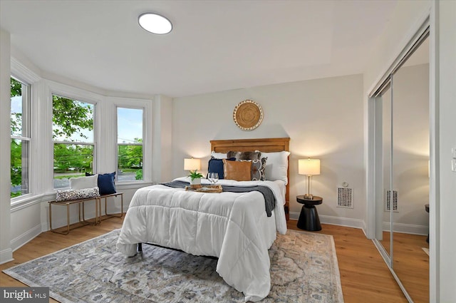 bedroom featuring light wood-type flooring and baseboards