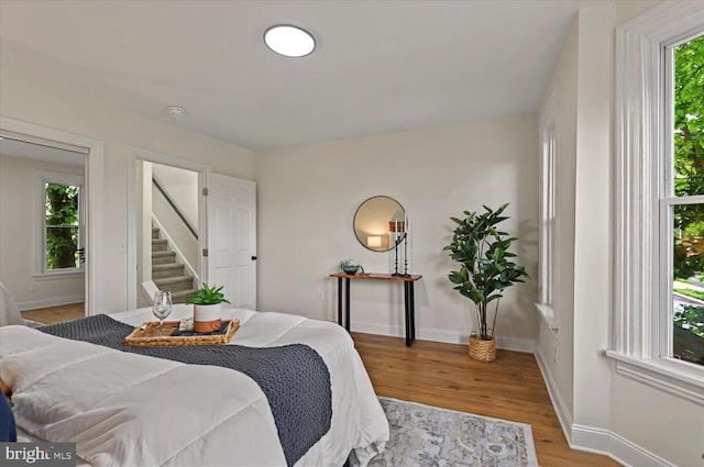 bedroom with light wood-style floors and baseboards