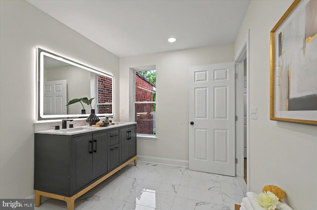 full bath with marble finish floors, recessed lighting, baseboards, and double vanity