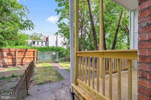 view of yard with fence, a gate, and a deck