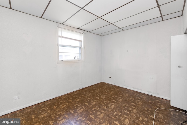 spare room with baseboards