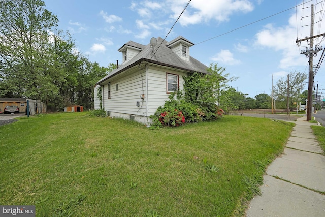view of side of property with a lawn