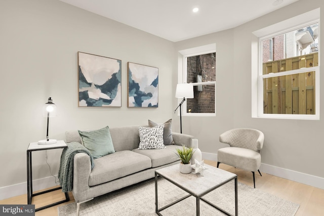 living area with wood finished floors, baseboards, and recessed lighting
