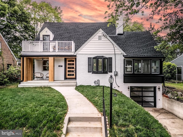 617 Greenbrier Dr, Silver Spring, MD 20910 - view of front facade with a balcony, roof with shingles, a front lawn, and brick siding