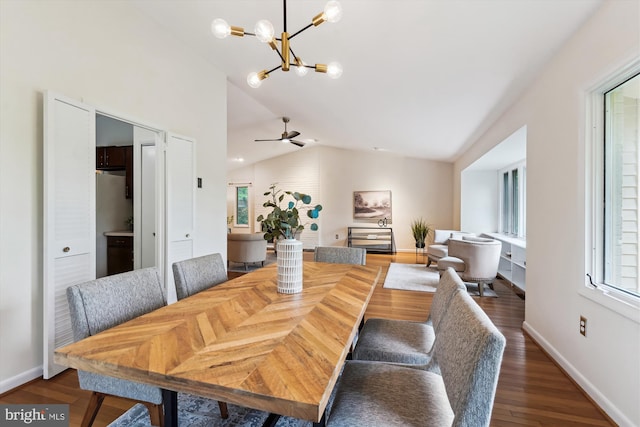 dining area featuring vaulted ceiling, plenty of natural light, a chandelier, wood finished floors, and baseboards