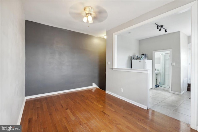 1331 Mifflin St, Philadelphia, PA 19148 - spare room featuring a ceiling fan, wood finished floors, baseboards, and track lighting