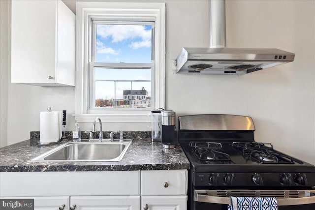 1331 Mifflin St, Philadelphia, PA 19148 - kitchen featuring black range with gas cooktop, wall chimney exhaust hood, white cabinets, and a sink