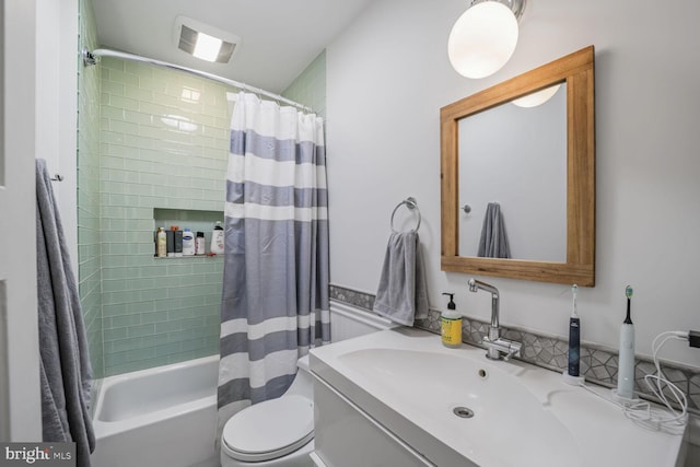 full bathroom with toilet, vanity, and shower / bath combo with shower curtain