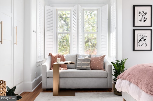bedroom featuring wood finished floors and baseboards