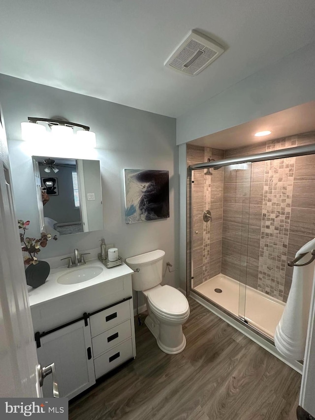 3133 Richmond St, Philadelphia, PA 19134 - full bath featuring a shower stall, wood finished floors, toilet, and vanity